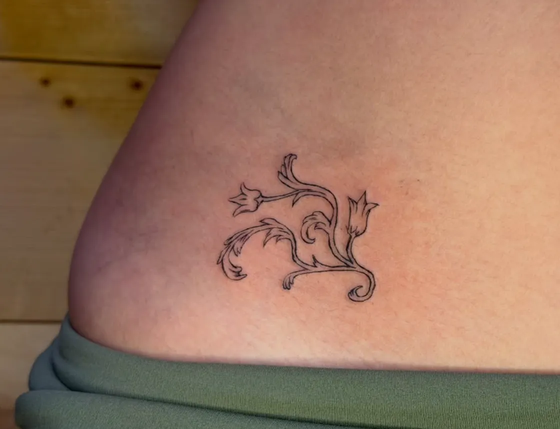 Fine line floral scroll on hip